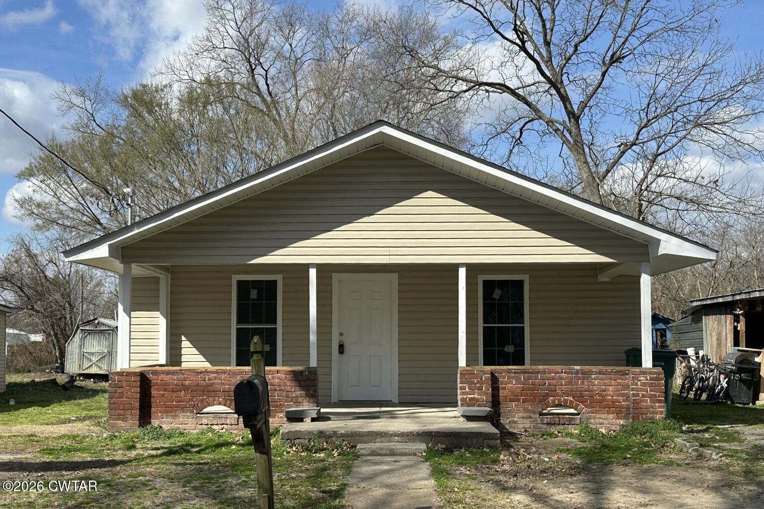 59 Holly Street Jackson, TN 38301 - Photo 1 of 24 a front view of house with yard outdoor seating and barbeque oven