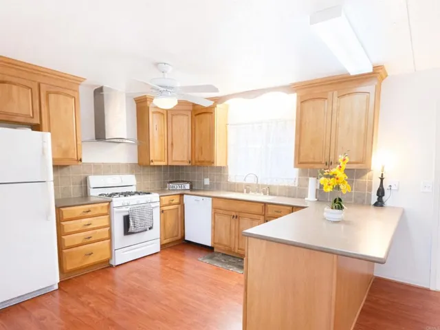 a kitchen with a stove a sink and a refrigerator