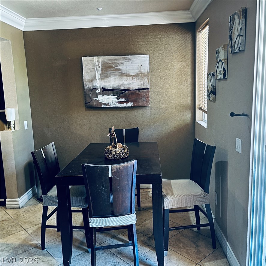 260 East Flamingo Road, Unit 118 Las Vegas, NV 89169 - Photo 8 of 9 A cozy dining area features elegant crown molding and ample natural light.