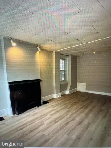 a view of an empty room and fire place