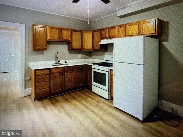 a kitchen with stainless steel appliances granite countertop a stove a sink dishwasher and a refrigerator