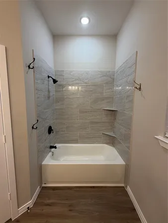 a bathroom with a bathtub and shower
