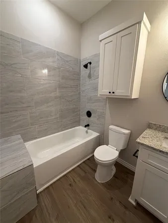 a bathroom with a toilet a sink and bathtub