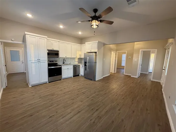 a view of a kitchen with a microwave and a refrigerator