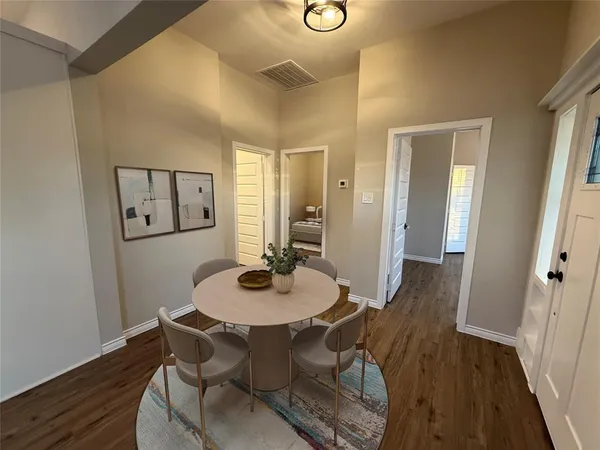 a dining room with furniture and wooden floor