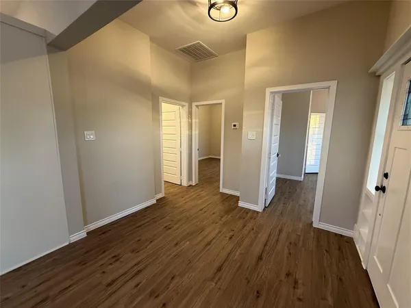 a view of a hallway with wooden floor