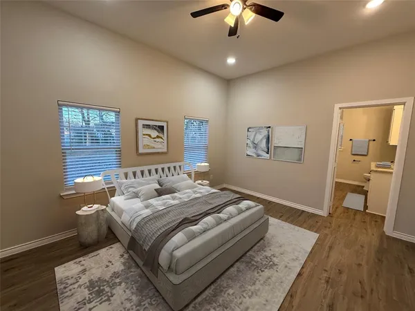 a bedroom with a large bed and a chandelier