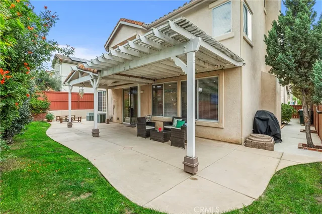 a view of a house with patio and a garden