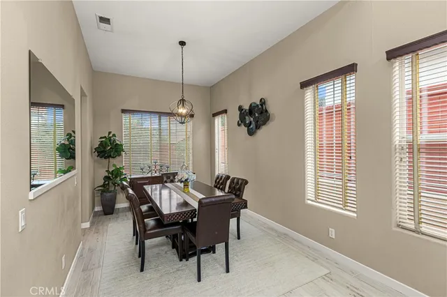 a dining room with furniture and window