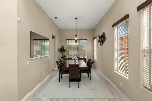 a dining room with furniture and window