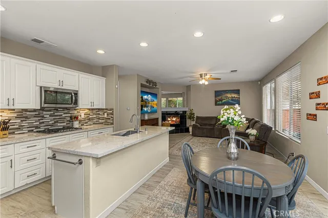 a kitchen with counter space dining table and chairs