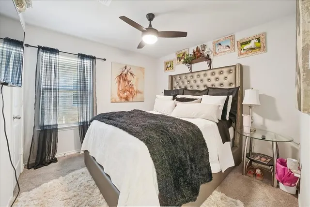 a spacious bedroom with a bed and a window