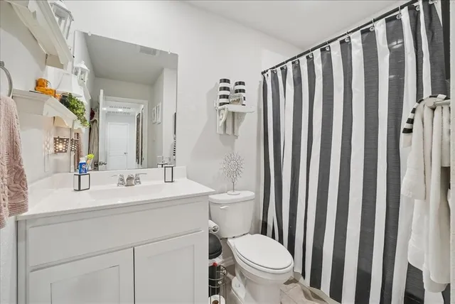 a bathroom with a toilet a sink and a mirror