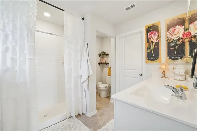 a bathroom with a sink mirror and shower