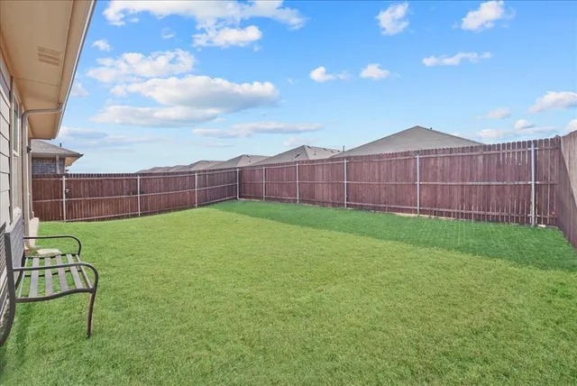 a view of yard with trampoline