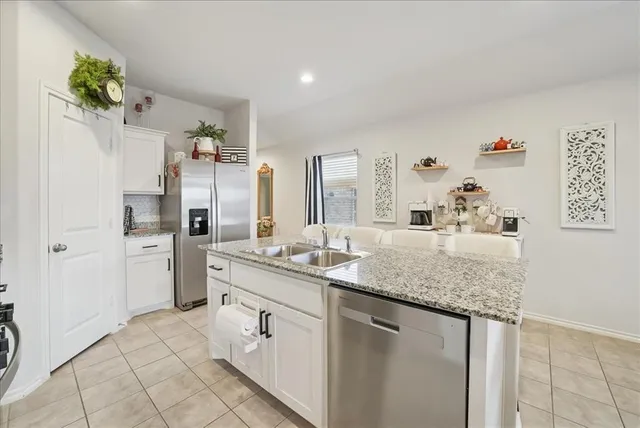 a bathroom with a granite countertop sink a mirror and a shower