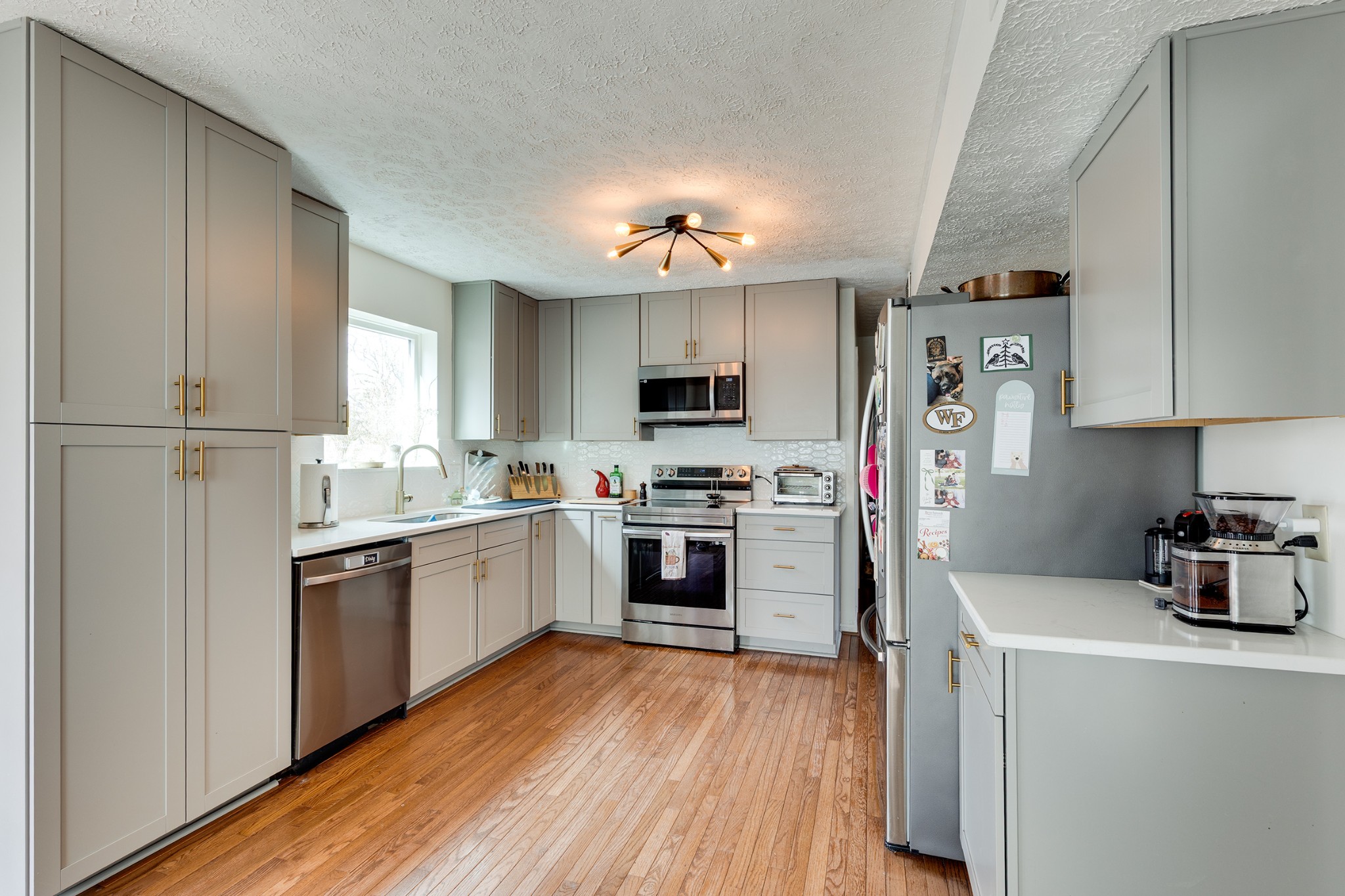 206 West Marthona Road Madison, TN 37115 - Photo 5 of 16 a kitchen with a refrigerator a stove top oven a sink dishwasher and wooden floor