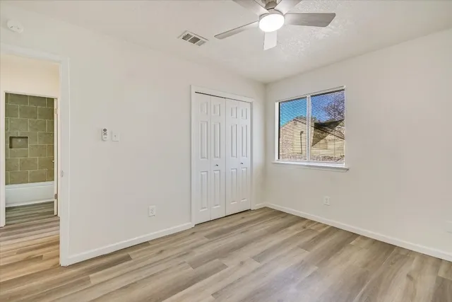 wooden floor in an empty room with a window