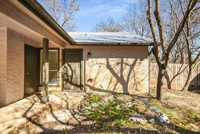 a view of house with backyard and trees