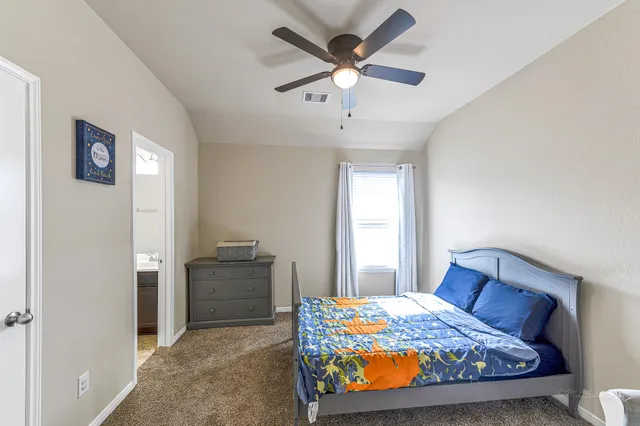 a bedroom with a bed and a chandelier