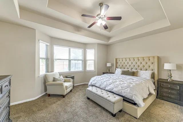 a bedroom with a bed couch and window