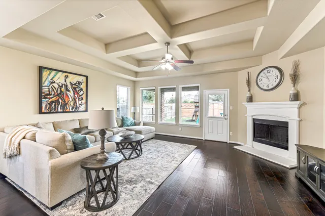 a living room with furniture a fireplace and a large window