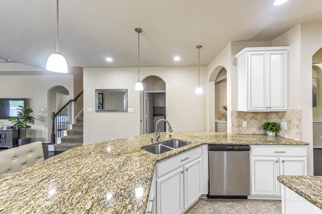 a large kitchen with kitchen island a sink stainless steel appliances and cabinets