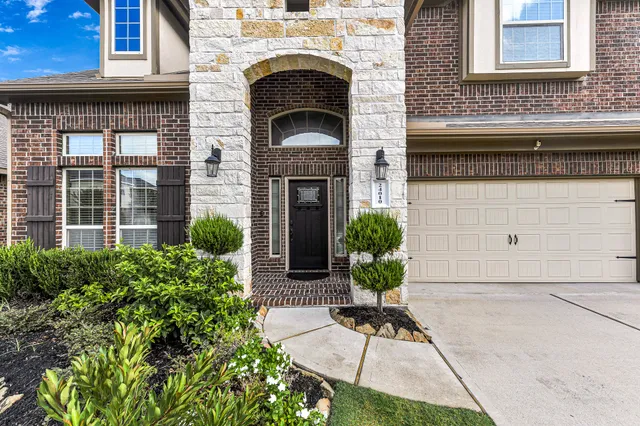 a house with potted plants in front of it