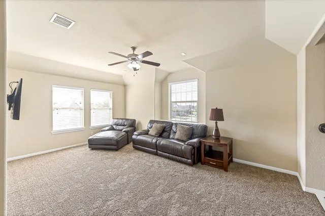 a living room with furniture and windows