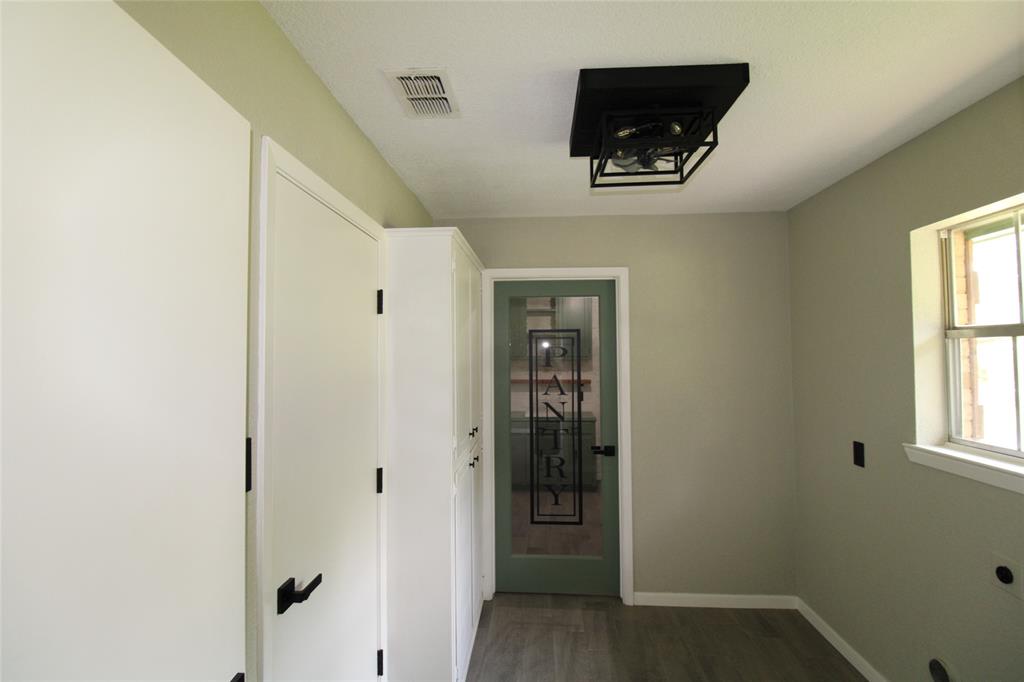 818 East Clinton Avenue Athens, TX 75751 - Photo 12 of 24 a hallway with closet and a window