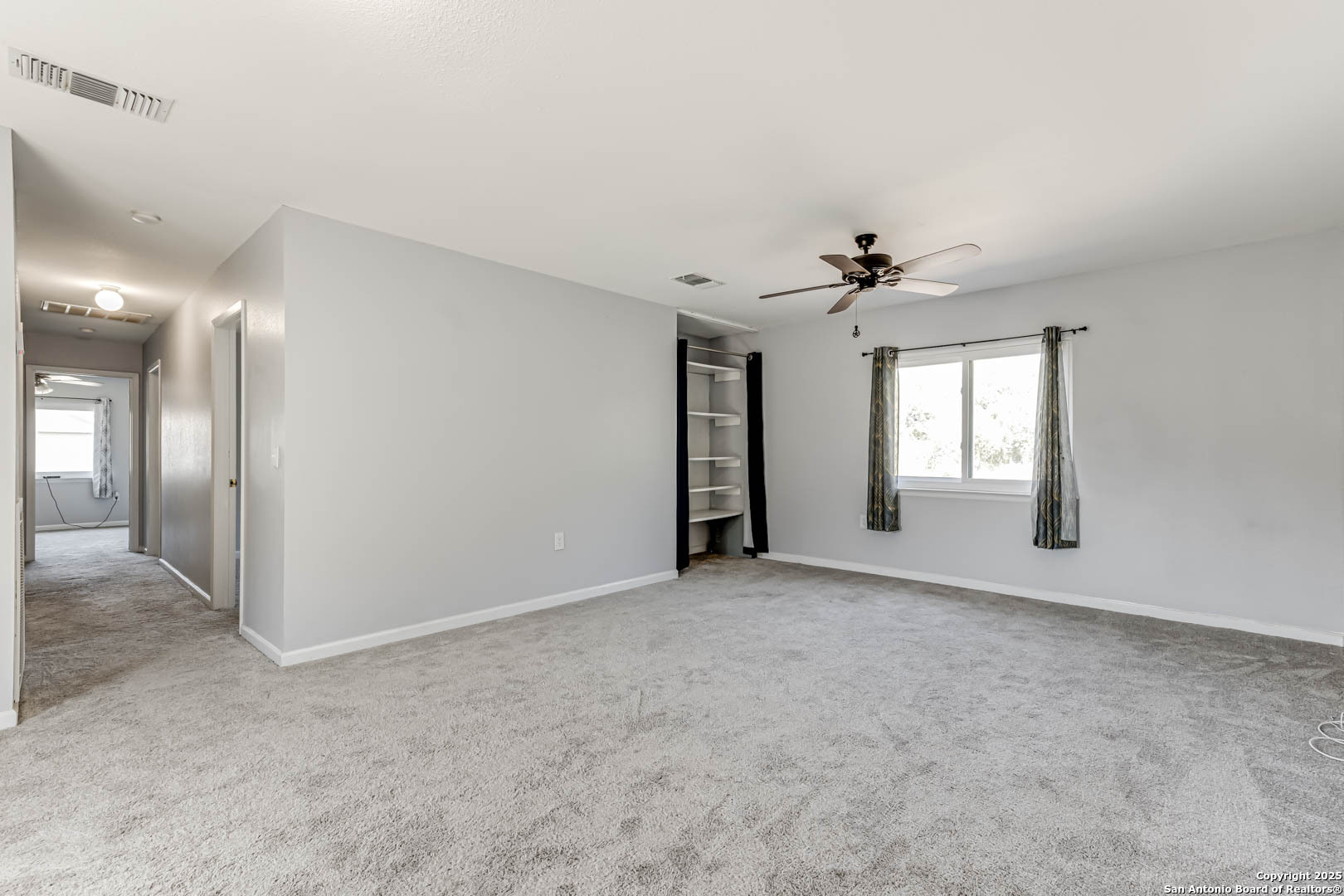 6719 Timberhill Leon Valley, TX 78238 - Photo 13 of 20 an empty room with fan and windows