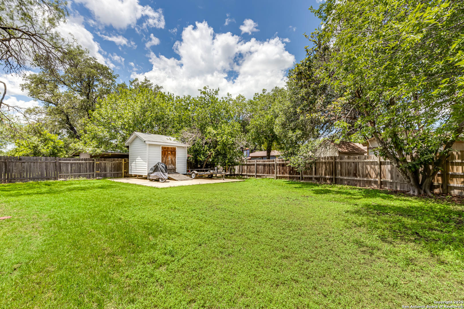 6719 Timberhill Leon Valley, TX 78238 - Photo 19 of 20 a view of a house with backyard and garden