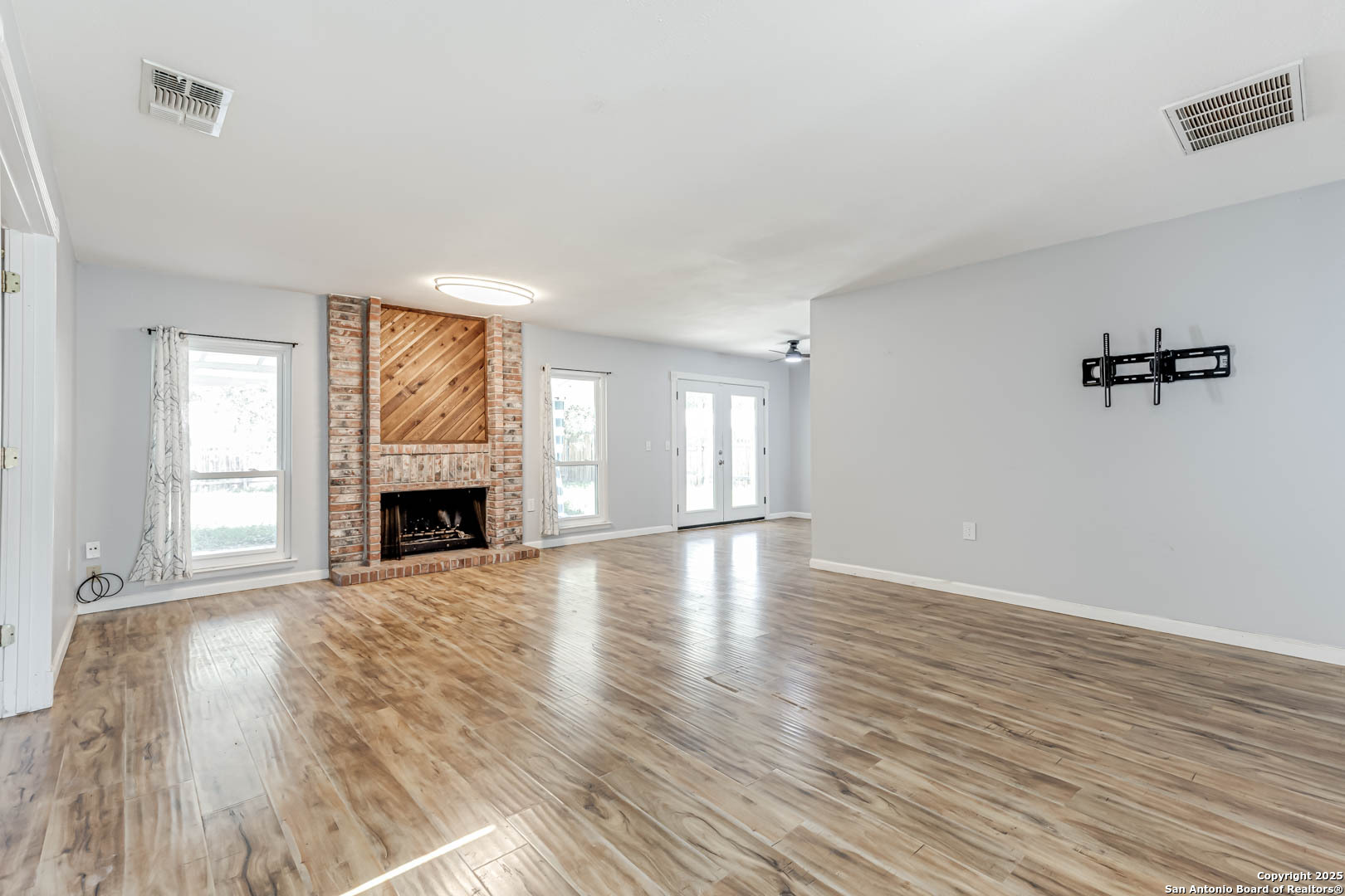 6719 Timberhill Leon Valley, TX 78238 - Photo 3 of 20 a view of empty room with wooden floor and fireplace