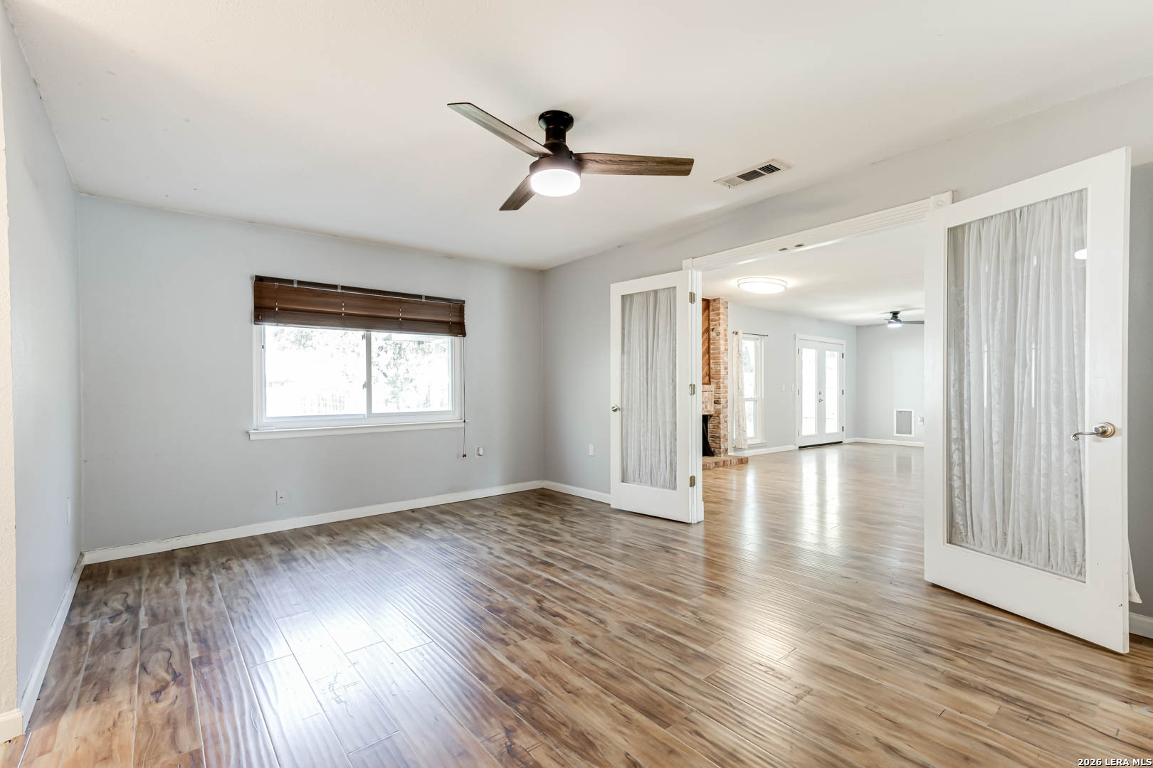 6719 Timberhill Leon Valley, TX 78238 - Photo 8 of 20 a view of an empty room with wooden floor and a window