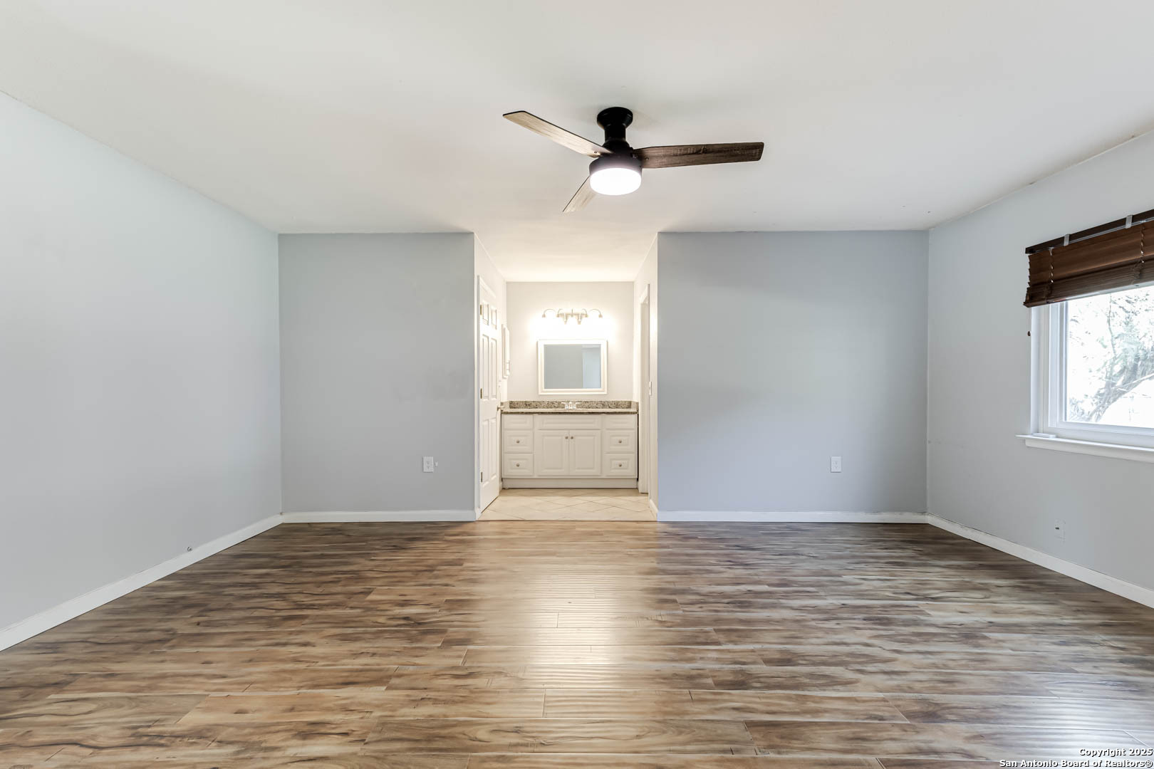 6719 Timberhill Leon Valley, TX 78238 - Photo 10 of 20 a view of empty room with wooden floor and fan