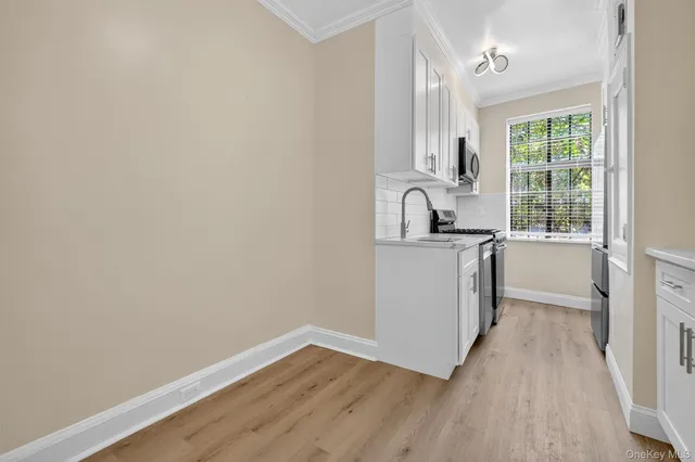 a kitchen with granite countertop a sink and a stove top oven