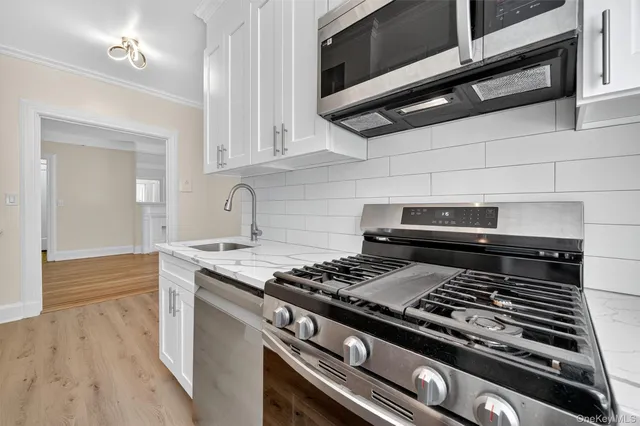 a stove top oven sitting inside of a kitchen