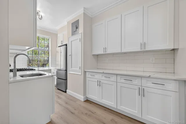 a kitchen with a sink cabinets and appliances