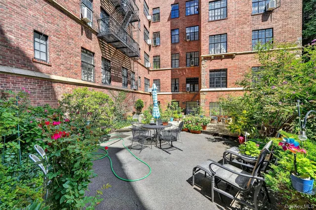a view of a patio with couches table and chairs and potted plants