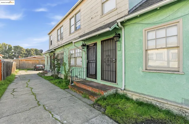 a view of a house with a large windows and plants