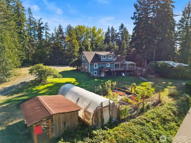 an aerial view of a house with swimming pool garden and patio