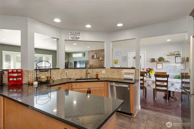 a kitchen with stainless steel appliances granite countertop a sink and cabinets
