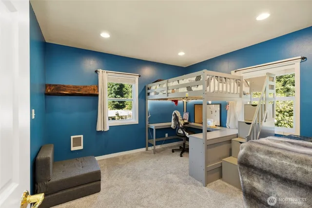 a bedroom with a bed and a chair