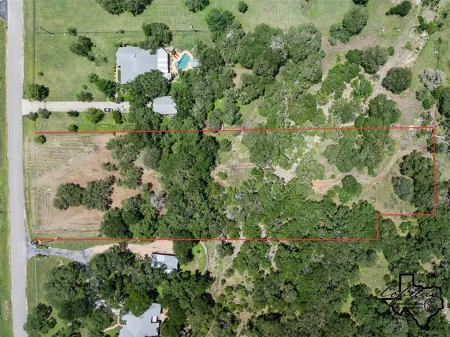 an aerial view of a house with a yard and garden