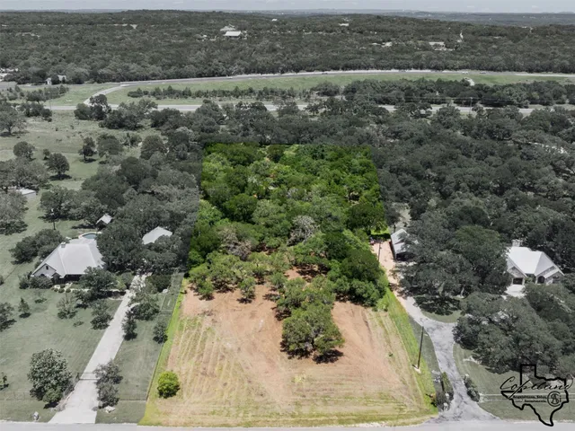 an aerial view of a houses with a yard