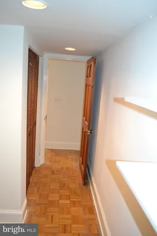 an empty room with closet and windows