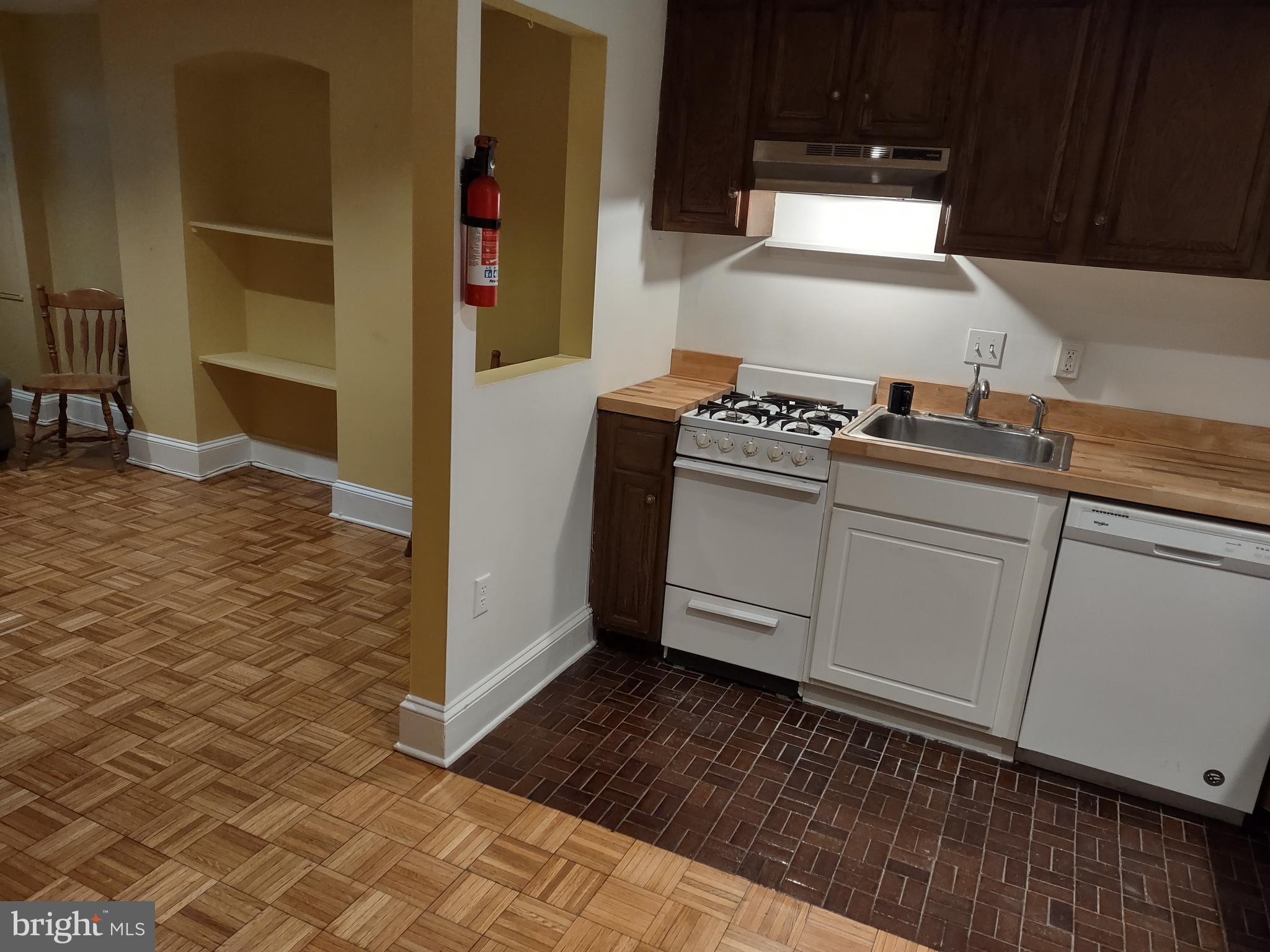810 D Street Southeast, Unit B Washington, DC 20003 - Photo 10 of 26 a kitchen with granite countertop a stove and a refrigerator
