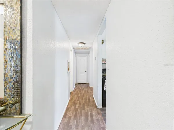 a view of a room with wooden floor