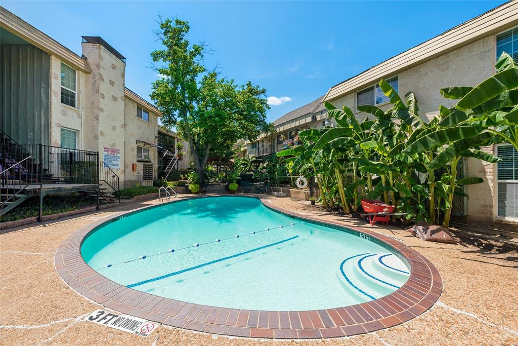 5109 Cedar Springs Road, Unit 105 Dallas, TX 75235 - Photo 15 of 16 Curved swimming pool with integrated steps and a brick coping