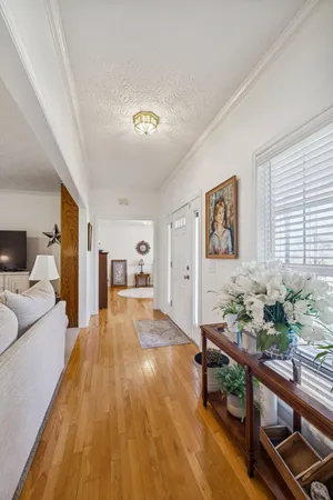 a living room with furniture and flowers
